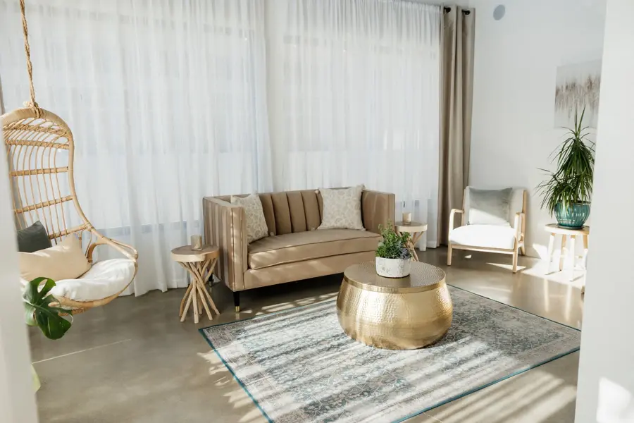 A Serenity Spa lounge, with a hanging rattan chair and warm natural textures